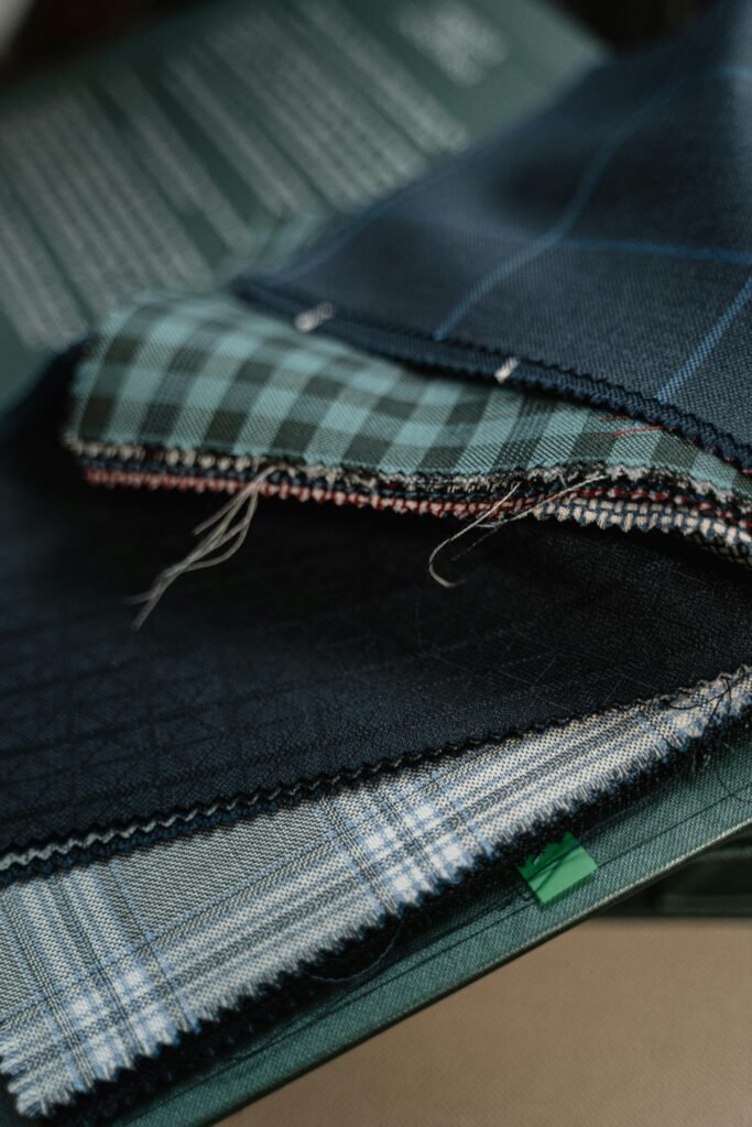 High-quality fabric swatches in various patterns for custom tailoring.